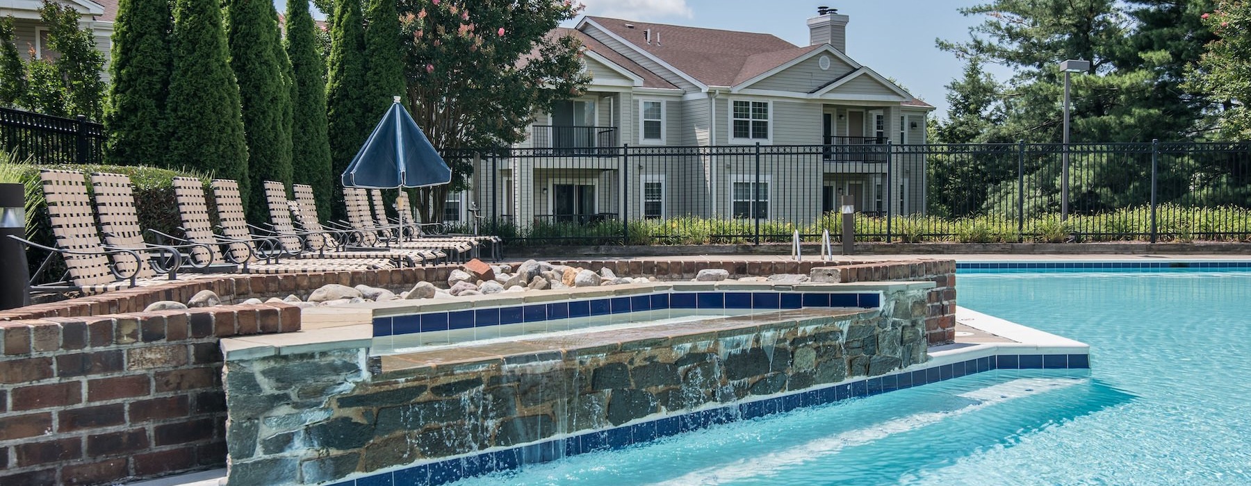 a swimming pool with lounge chairs