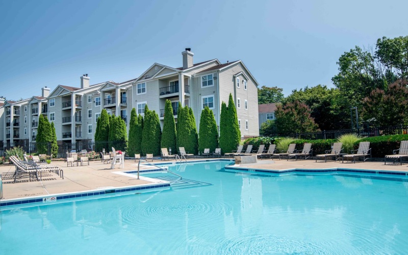 a swimming pool with chairs around it