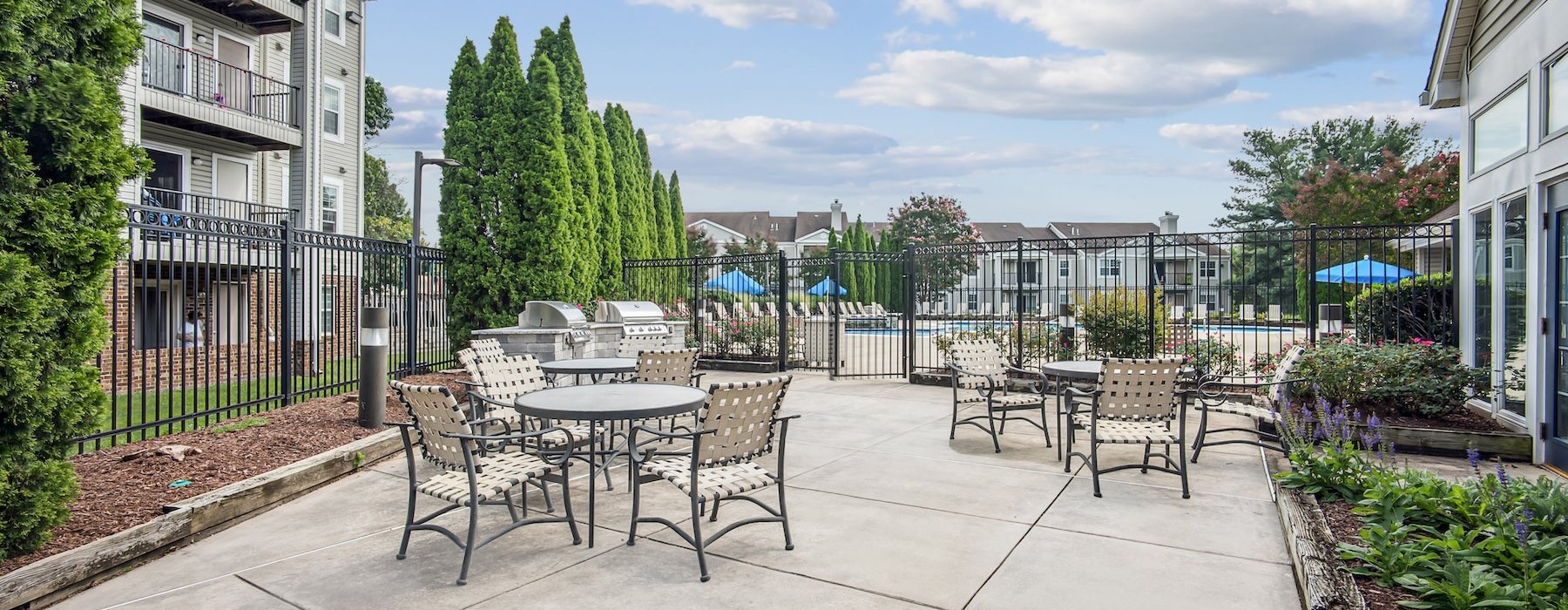 a patio with tables and chairs