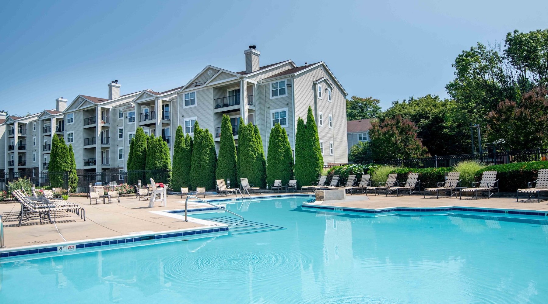 a swimming pool with lounge chairs