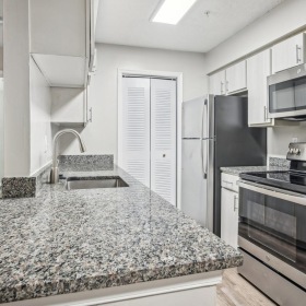 a kitchen with marble counters
