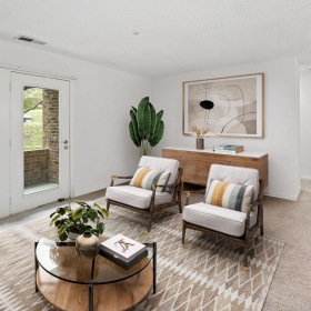 a living room with a table and chairs